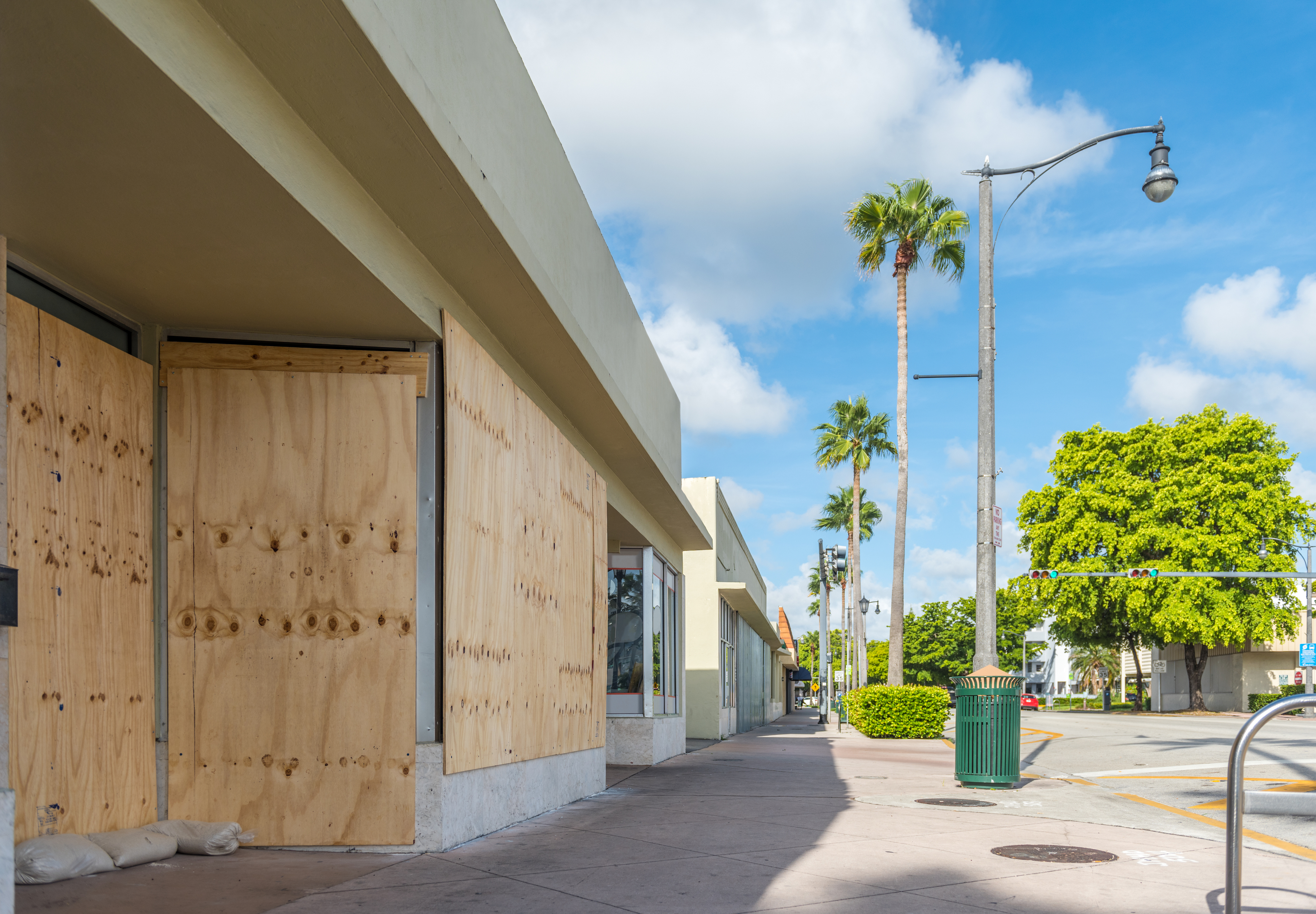 Boarded up windows and an approaching storm