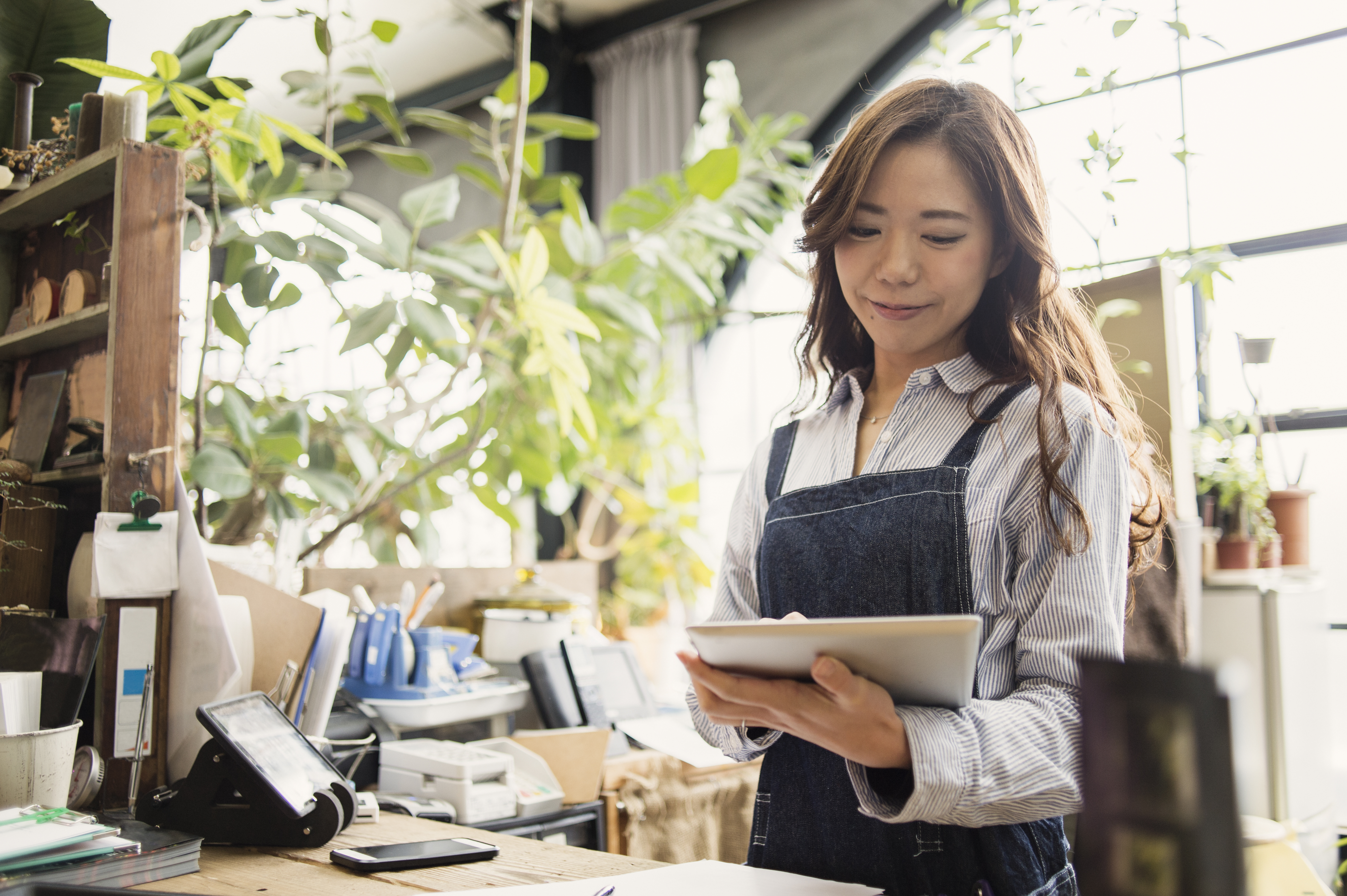 Female gardener working in flower shop