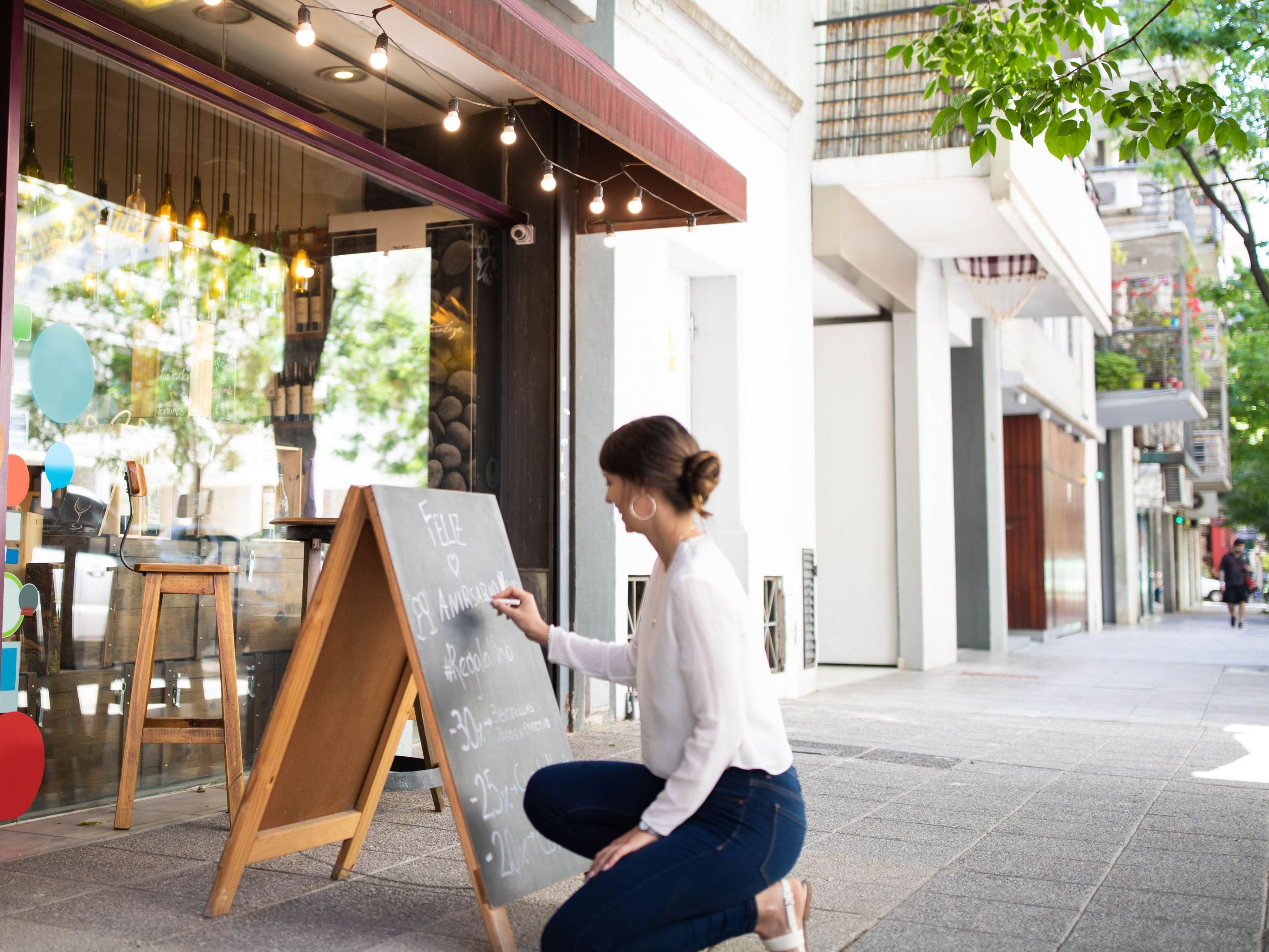 Business owner writing on foot traffic sign